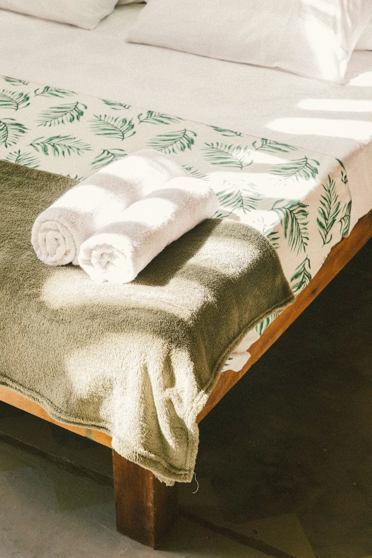 Toallas blancas dobladas sobre la cama de la cabaña
